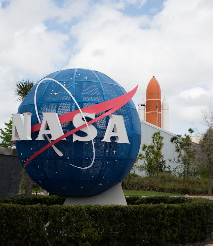 NASA globe with a rocket in the background at Kennedy Space Center in Florida.